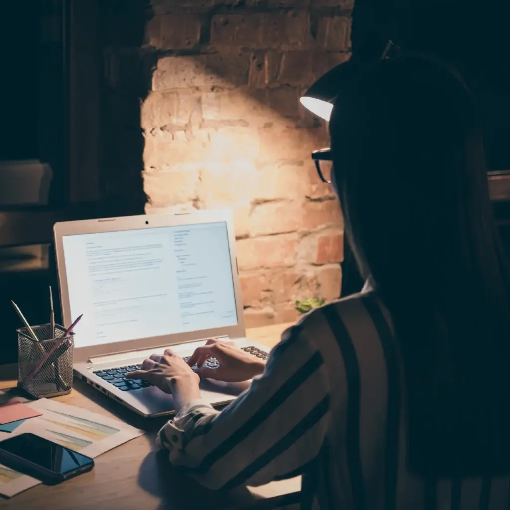 A woman working at night.